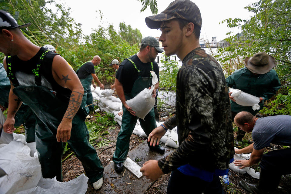 <p>Volunteers put out sand bags due to the arrival of Tropical Storm Cindy in Lafitte, La., Wednesday, June 21, 2017. Tropical Storm Cindy sent drenching rain bands over the north Gulf Coast on Wednesday, swamping low-lying coastal roads and pushing a waterspout ashore in one beachfront community as residents from east Texas to the Florida Panhandle warily eyed the storm’s slow crawl toward land. (Photo: Gerald Herbert/AP) </p>