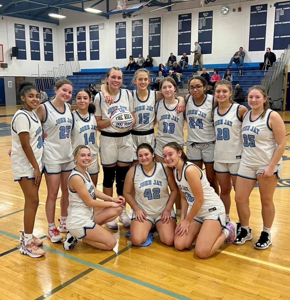 John Jay's Ashley Buragas poses with her girls basketball teammates after recording her 1,000th career rebound during a Feb. 7, 2023 game. The senior also has 1,000 career points.