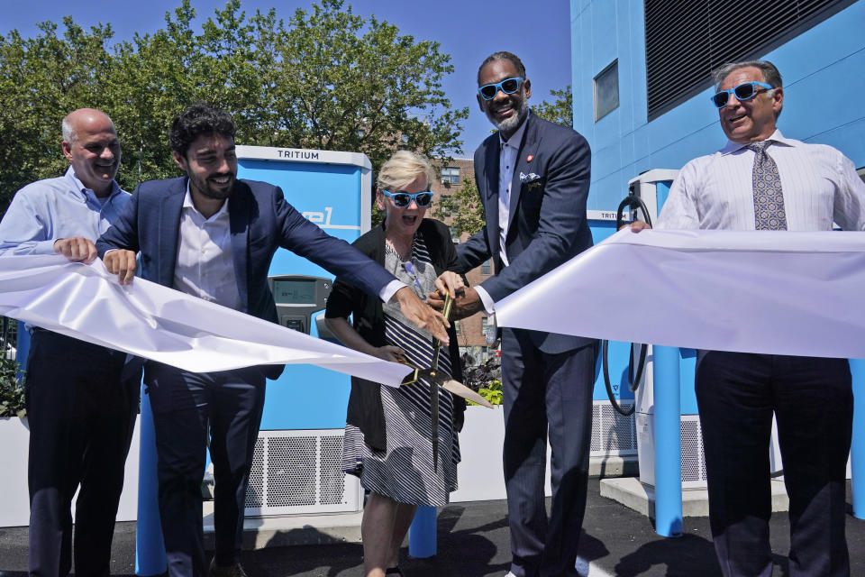 Timothy Cawley, president of Con Edison, left, Frank Reig, Revel founder and CEO, second from left, Secretary of Energy Jennifer Granholm, center, Councilman Robert Cornegy, Jr., second from right, and Mike Calise, Americas president of Tritium, cut the ribbon at an opening ceremony for an electric vehicle charging hub in the Brooklyn borough of New York, Tuesday, June 29, 2021. Granholm is visiting the state to promote President Joe Biden's sweeping infrastructure plan. (AP Photo/Seth Wenig)