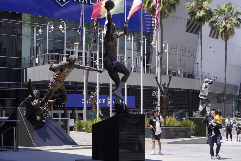 FILE - People visit the Star Plaza of Crypto.com Arena on July 25, 2023, in Los Angeles. The Los Angeles Lakers will unveil a statue of Kobe Bryant outside their downtown arena on Feb. 8, 2024. The 17-time NBA champion Lakers announced the plan Thursday, Aug. 24, 2023, to honor Bryant, the fourth-leading scorer in NBA history and a beloved mainstay of the franchise for 20 seasons. (AP Photo/Damian Dovarganes, File)