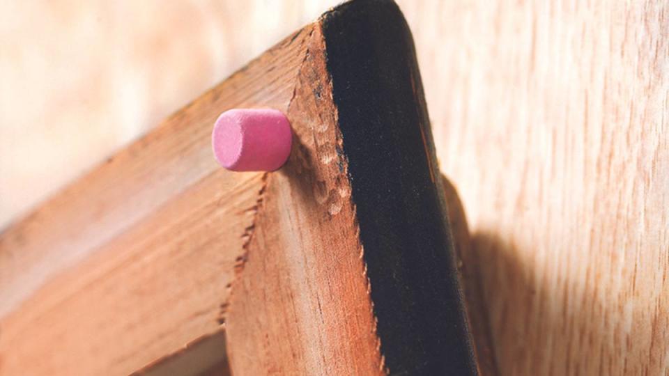 uses for pencil erasers: Keep frames from scratching walls