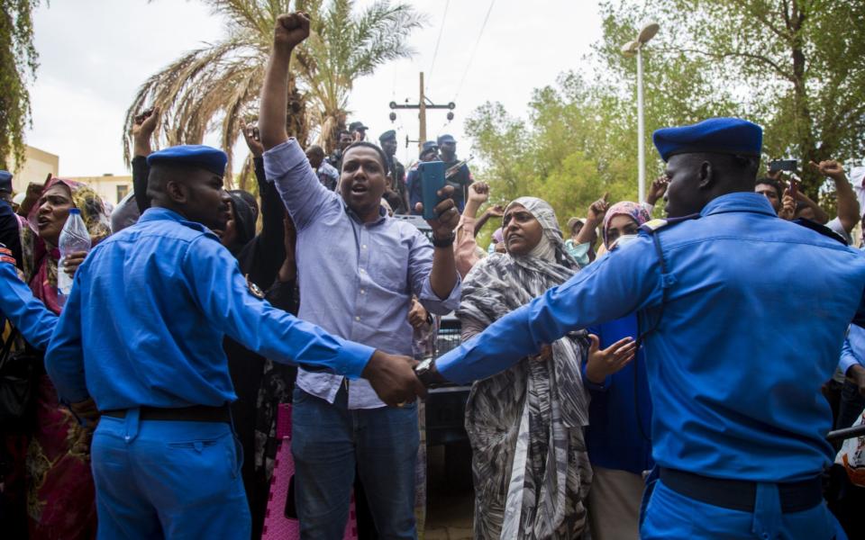 Supporters of ousted former Sudanese President Omar al-Bashir shout slogans at the Judicial and Legal Science Institute - Mahmoud Hjaj/Anadolu Agency via Getty Images