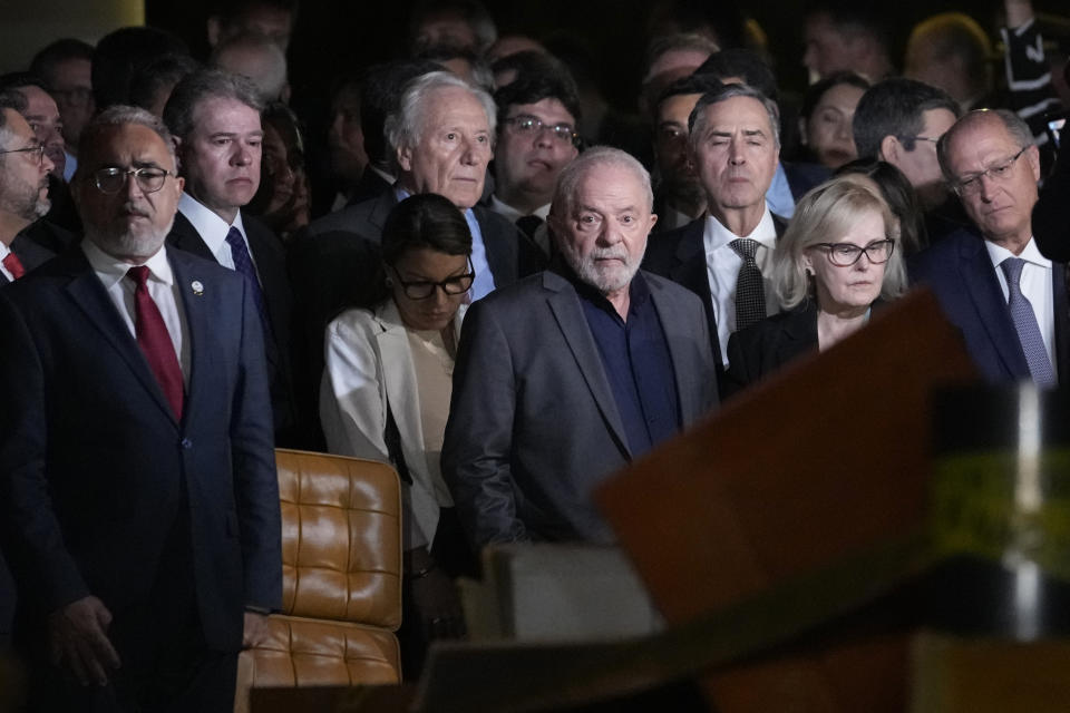 FILE - Brazil's President Luiz Inacio Lula da Silva, center, President of the Supreme Court Rosa Weber, center right, are accompanied by governors and ministers for an inspection visit of the Supreme Court, a day after Congress was stormed by supporters of former Brazilian President Jair Bolsonaro in Brasilia, Brazil, Jan. 9, 2023. Mimicking the Jan. 6, 2021, insurrection by defenders of outgoing U.S. President Donald Trump at the Capitol in Washington, thousands of Bolsonaro’s supporters stormed the presidential palace on Jan. 8, 2023, Congress and the Supreme Court buildings, in one of the biggest challenges to Latin America’s most populous democracy. (AP Photo/Eraldo Peres, File)