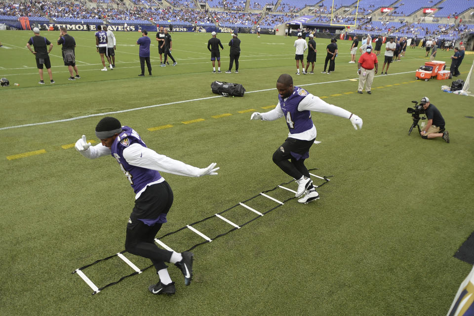 Baltimore Ravens' Marlon Humphrey, left, and Chris Smith practice their footwork during practice at NFL football training camp Saturday, July 31, 2021, in Baltimore. (AP Photo/Gail Burton)