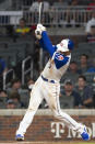 Freddie Freeman hits a single during the eighth inning of the team's baseball game against the Milwaukee Brewers, Saturday, July 31, 2021, in Atlanta. (AP Photo/Hakim Wright Sr.)