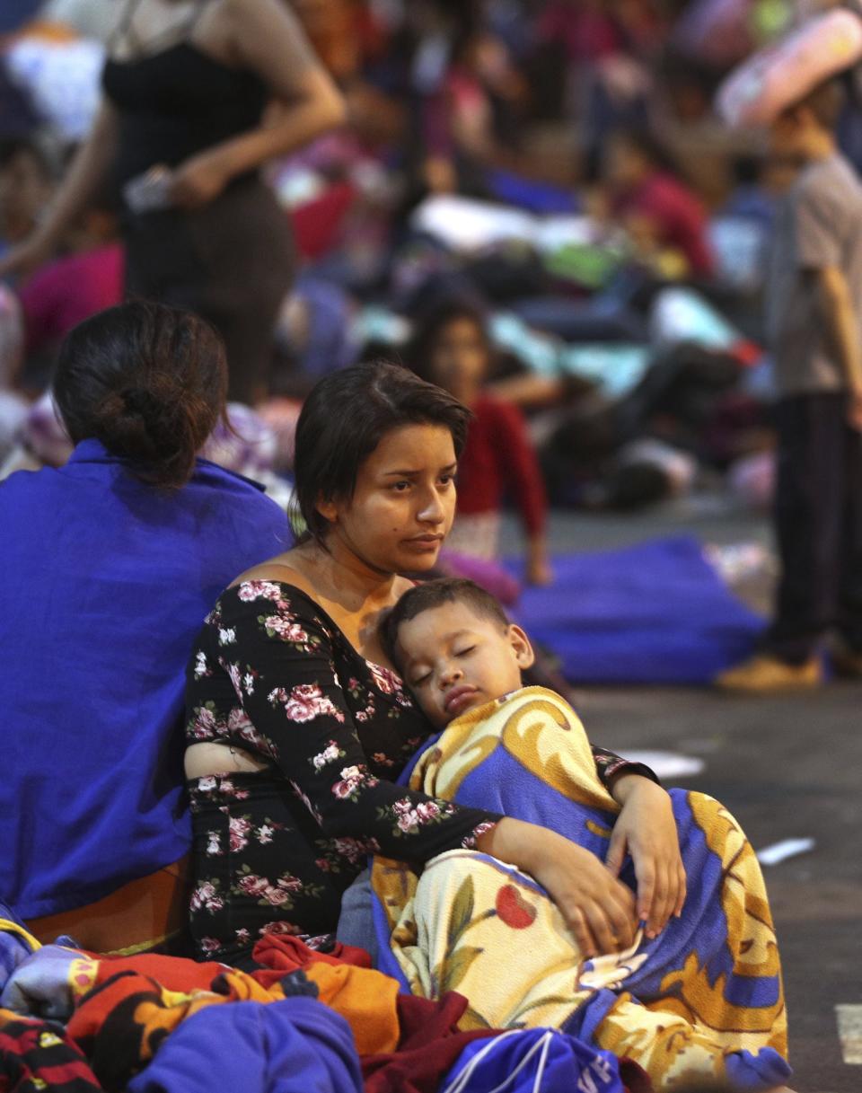 Venezuelan migrants migrants wait to pass migration controls before the deadline on new regulations, in Tumbes, Peru, Friday, June 14, 2019. Venezuelan citizens are rushing to enter Peru before the implementation of new entry requirements on migrants fleeing the crisis-wracked South American nation. (AP Photo/Martin Mejia)