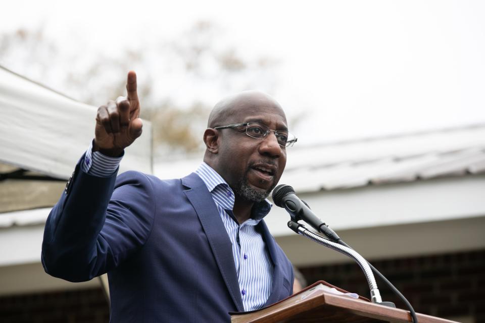 Democratic U.S. Senate candidate Raphael Warnock speaks to church members during a drive-up worship service at St. James Missionary Baptist Church on Sunday in Columbus, Georgia. Warnock is facing incumbent Sen. Kelly Loeffler in a runoff election that will take place on January 5th.  The results of two Georgia U.S. Senate races will determine which party controls the Senate.