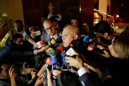 Jesus Torrealba (C), secretary of Venezuela's coalition of opposition parties (MUD), talks to the media after his meeting with international mediators for talks between government and opposition in Caracas, Venezuela December 6, 2016. REUTERS/Marco Bello