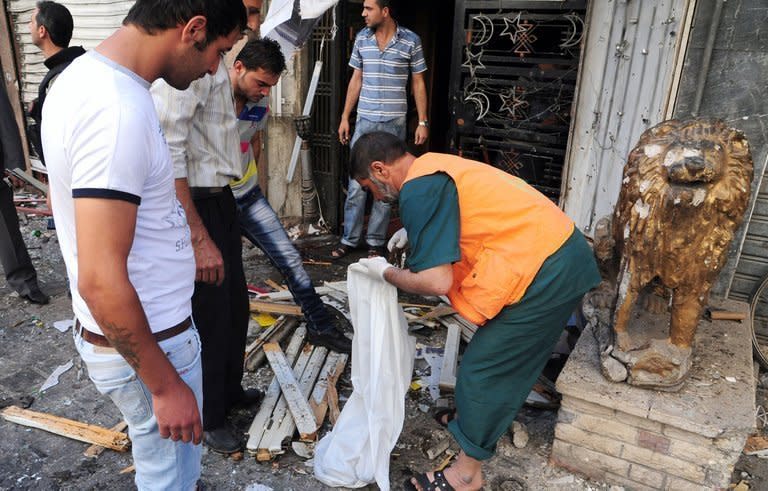An image released by the Syrian Arab News Agency on June 11, 2013, shows Syrians inspecting the damage in central Damascus following two explosions