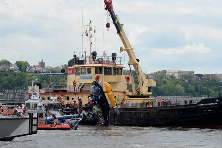 A Helicopter that crashed into the Hudson River is lifted on to the deck of an Army Corp of Engineers boat in New York City, U.S., May 15, 2019. REUTERS/Jefferson Siegel