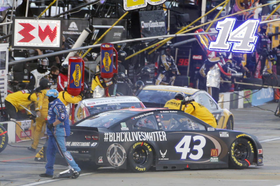 Bubba Wallace (43) makes a pit stop during a NASCAR Cup Series auto race Wednesday, June 10, 2020, in Martinsville, Va. (AP Photo/Steve Helber)