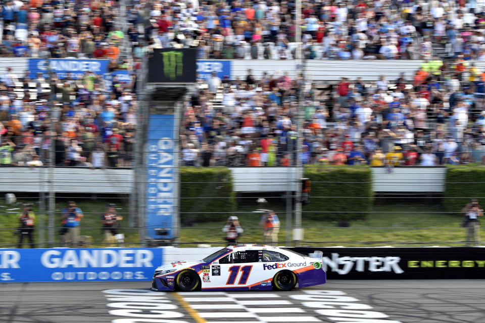 Denny Hamlin crosses the finish line to win a NASCAR Cup Series auto race, Sunday, July 28, 2019, in Long Pond, Pa. (AP Photo/Derik Hamilton)