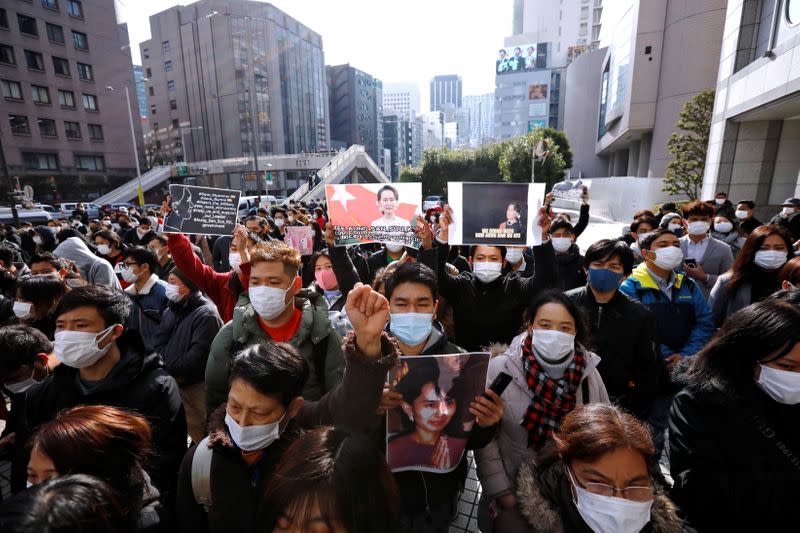 Myanmar protesters residing in Japan hold signs and photos of Aung San Suu Kyi as they rally against Myanmar's military after it seized power from a democratically elected civilian government and arrested its leader Aung San Suu Kyi, in Tokyo