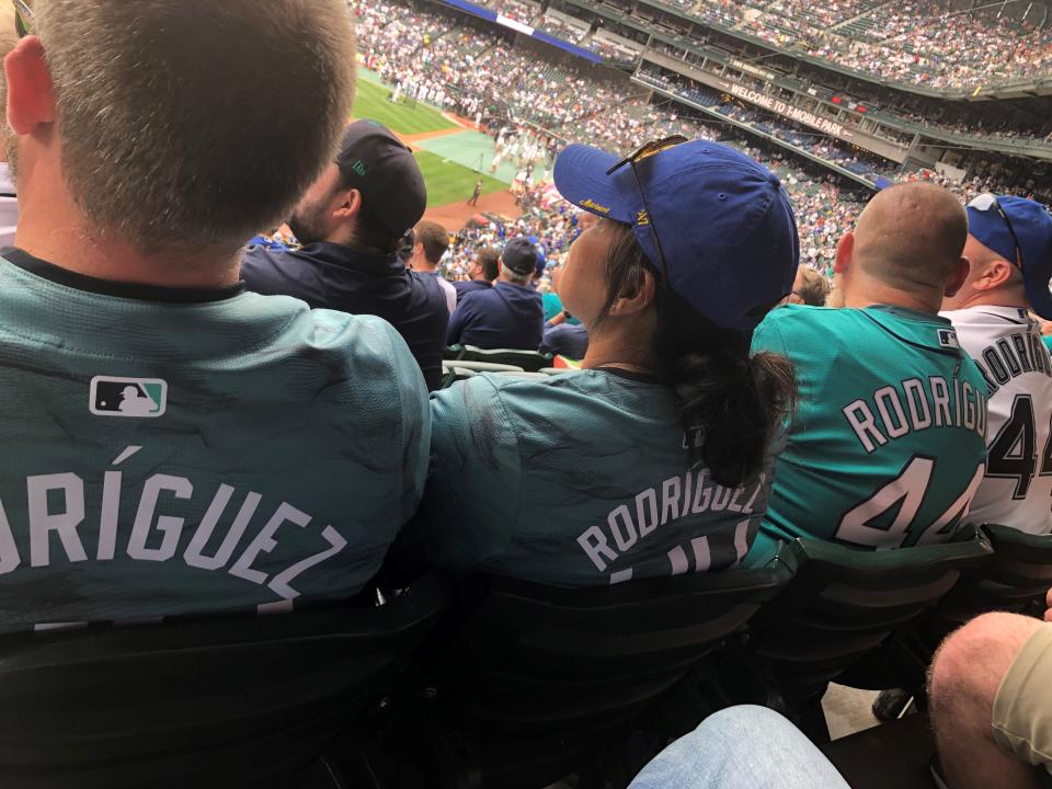 Fans clad in Julio Rodriguez jerseys - two from the All-Star Game - watch workouts at T-Mobile Park.