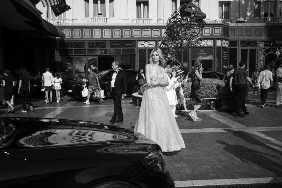 A festivalgoer leaves from the Majestic hotel for the premiere of the film 'Triangle of Sadness' at the 75th international film festival, Cannes, southern France, Saturday, May 21, 2022. (AP Photo/Petros Giannakouris)