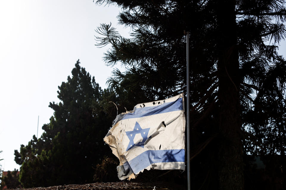 A tattered Israeli national flag is seen in the kibbutz Nir Oz in southern Israel.