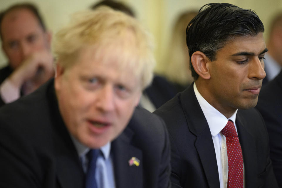 FILE - Britain's Chancellor Rishi Sunak, right, listens as Britain's Prime Minister Boris Johnson addresses his Cabinet during his weekly Cabinet meeting in Downing Street, June 7, 2022 in London. Two of Britain’s most senior Cabinet ministers have quit on Tuesday, July 5, 2022, a move that could spell the end of Prime Minister Boris Johnson’s leadership after months of scandals. Treasury chief Rishi Sunak and Health Secretary Sajid Javid resigned within minutes of each other. (Leon Neal/Pool Photo via AP, file)