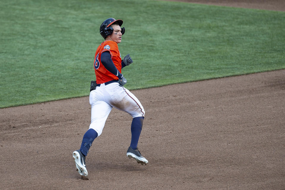 Virginia's Zack Gelof runs after hitting the ball for a double against Tennessee in the third inning during a baseball game in the College World Series, Sunday, June 20, 2021, at TD Ameritrade Park in Omaha, Neb. (AP Photo/John Peterson)