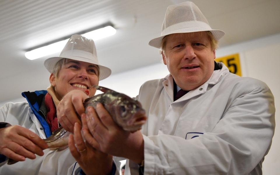 Britain's Prime Minister Boris Johnson visits Grimsby Fish Market in Grimsby -  REUTERS