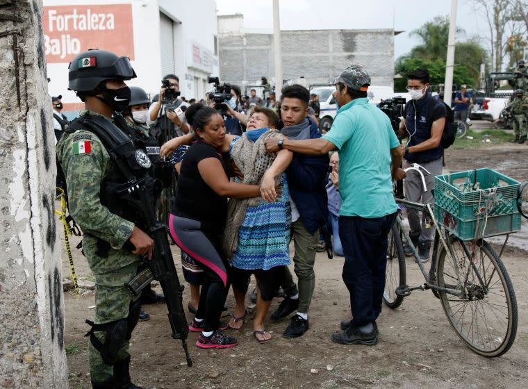 A woman reacts near the crime scene where 24 people were killed in Irapuato, Guanajuato state, Mexico, on July 1, 2020. - An armed attack at a drug rehabilitation center in Irapuato, a town in the central Mexican state of Guanajuato, left at least 24 dead and seven wounded on Wednesday, local authorities reported. (Photo by MARIO ARMAS / AFP) (Photo by MARIO ARMAS/AFP via Getty Images)