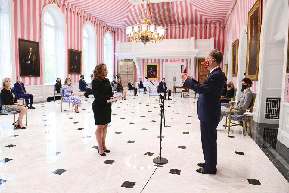 Prime Minister Justin Trudeau, right, looks on with Gov. Gen. Julie Payette as Chrystia Freeland is sworn in as Finance Minister by Clerk of The Privy Council Ian Shugart during a cabinet shuffle at Rideau Hall in Ottawa on Tuesday, Aug. 18, 2020. (Sean Kilpatrick/The Canadian Press via AP)