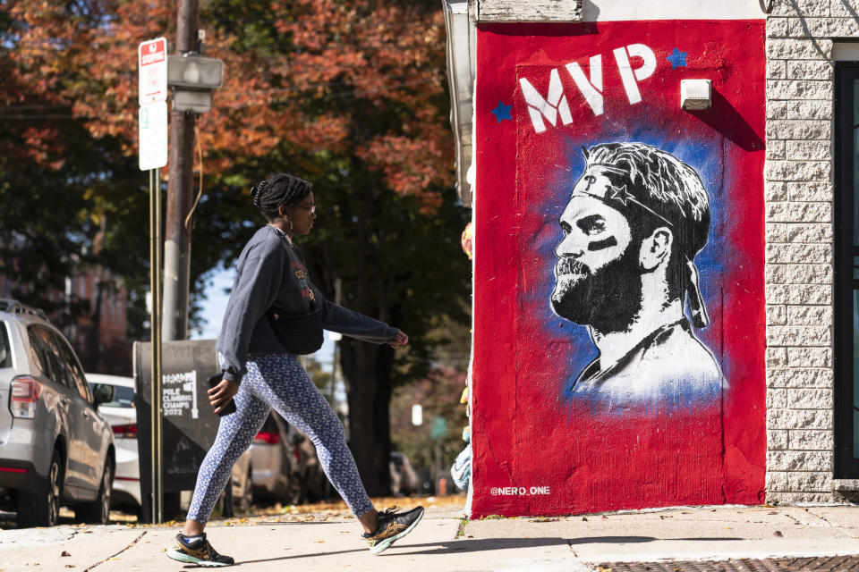 A person walks past a mural of Philadelphia Phillies designated hitter Bryce Harper, created by artist Nero, in Philadelphia, Thursday, Oct. 27, 2022. Game 1 of baseball's World Series between the Phillies and Houston Astros is Friday in Houston. (AP Photo/Matt Rourke)