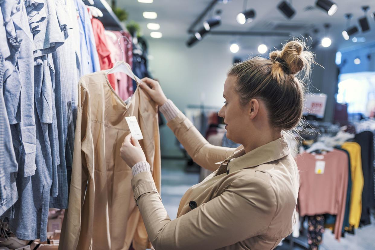 woman looking at clothes in store