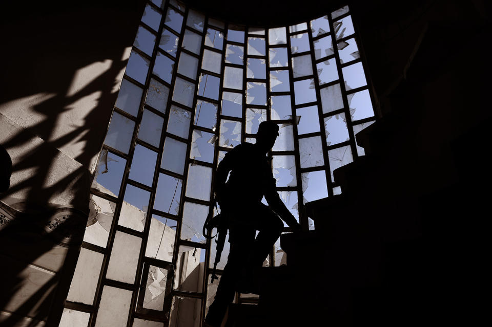 <p>A member of the Iraqi federal police walks up the stairs of a house in the city of Mosul while Iraqi forces fight against jihadists on Feb. 26, 2017, during an operation to retake the city from Islamic State (IS) group fighters. (Aris Messinis/AFP/Getty Images) </p>