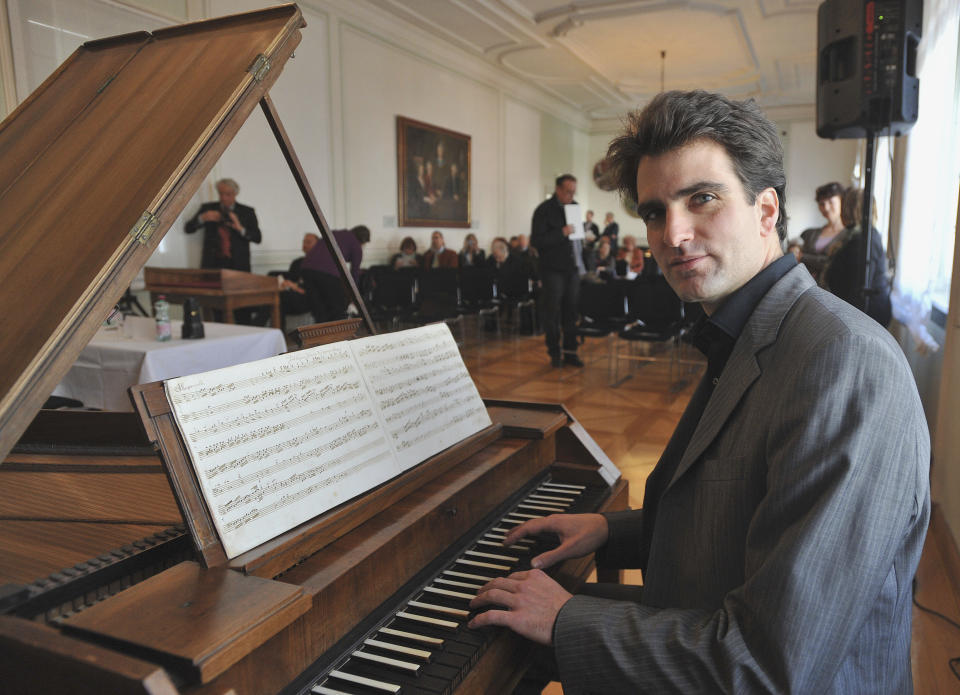 Pianist Florian Birsack plays on a piano forte during a press conference held by the research department of the International Mozarteum Foundation in Salzburg, Austria, Friday, March 23, 2012. Previously unknown sheets of Music from Wolfgang Amadeus Mozart were discovered in Tyrol in Austria. The Mozart Foundation in Salzburg says that the piece was found in a hand written music book from 1780. (AP Photo/ Kerstin Joensson)