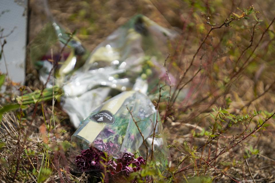 Bouquets of flowers are pictured at the site of a weekend fatal train collision that killed six people and left another in critical condition, when they were crossing the train tracks, on their way to a birthday party, Monday, Sept. 25, 2023 in Plant City, Fla. The weekend crash between a train and a sports-utility vehicle that killed six people in Florida happened at a private road crossing where little more than a sign or two is required, no crossing gates, no flashing lights, no sound. (Martha Asencio-Rhine/Tampa Bay Times via AP)