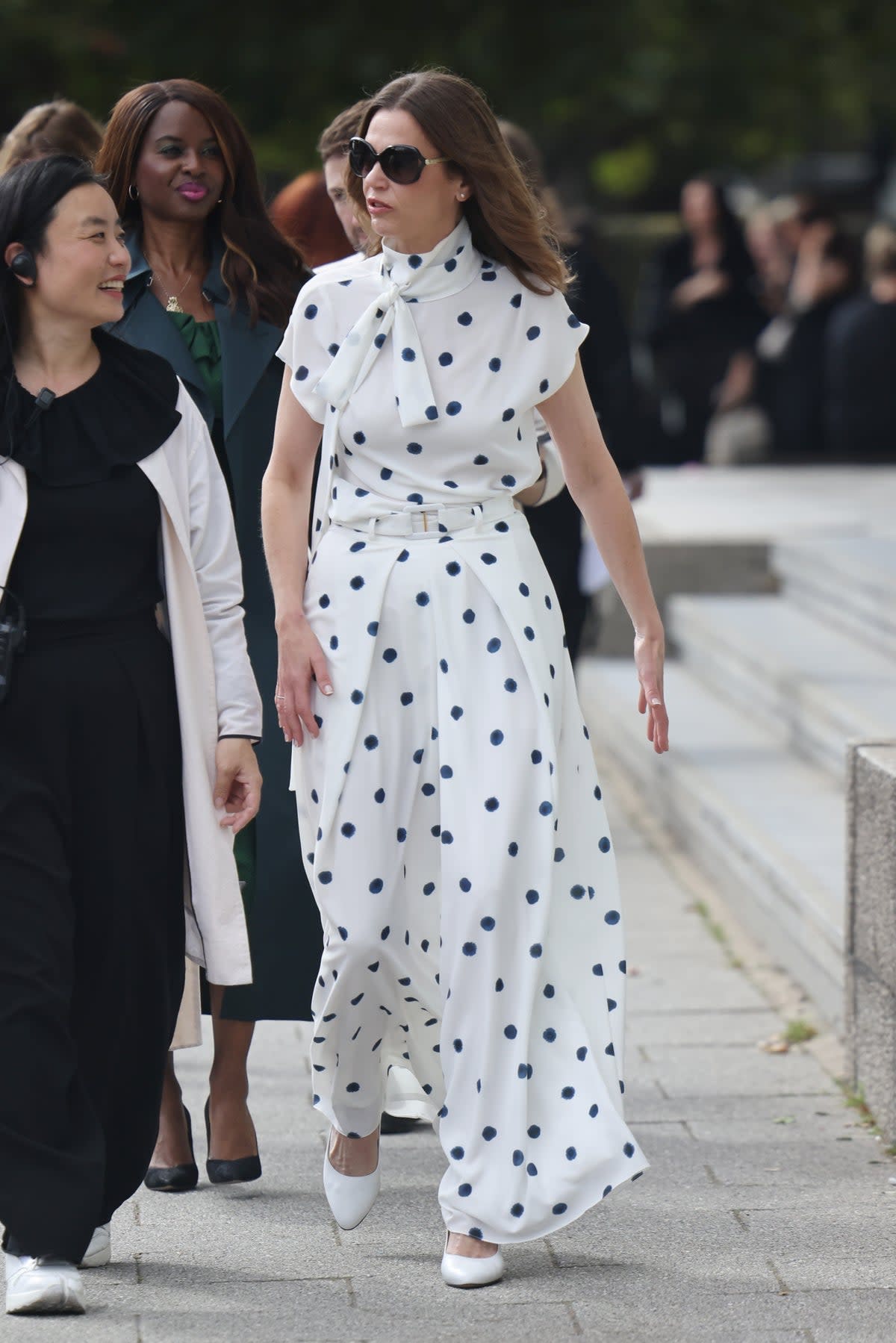 Victoria Starmer (in a white spotty dress and blue jacket) at Edeline Lee at Millbank Tower during London Fashion Week (GC Images)