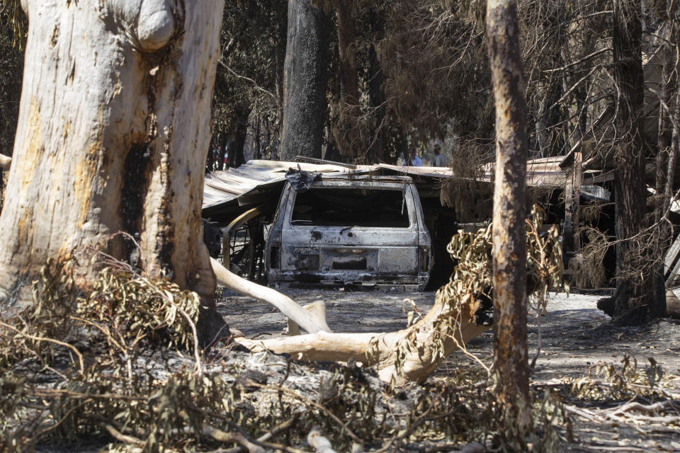 Damage caused by bushfire is seen at resident Brian Williams' resort at Lake Cooroibah Road in Noosa Shire, Queensland, Australia, Monday, Nov. 11, 2019. Australia’s most populous state New South Wales declared a state of emergency on Monday due to unprecedented wildfire danger as calls grew for Australia to take more action to plan for an counter climate change. New South Wales state Emergency Services Minister David Elliott said residents were facing what "could be the most dangerous bushfire week this nation has ever seen.” (Rob Maccoll/AAP Images)