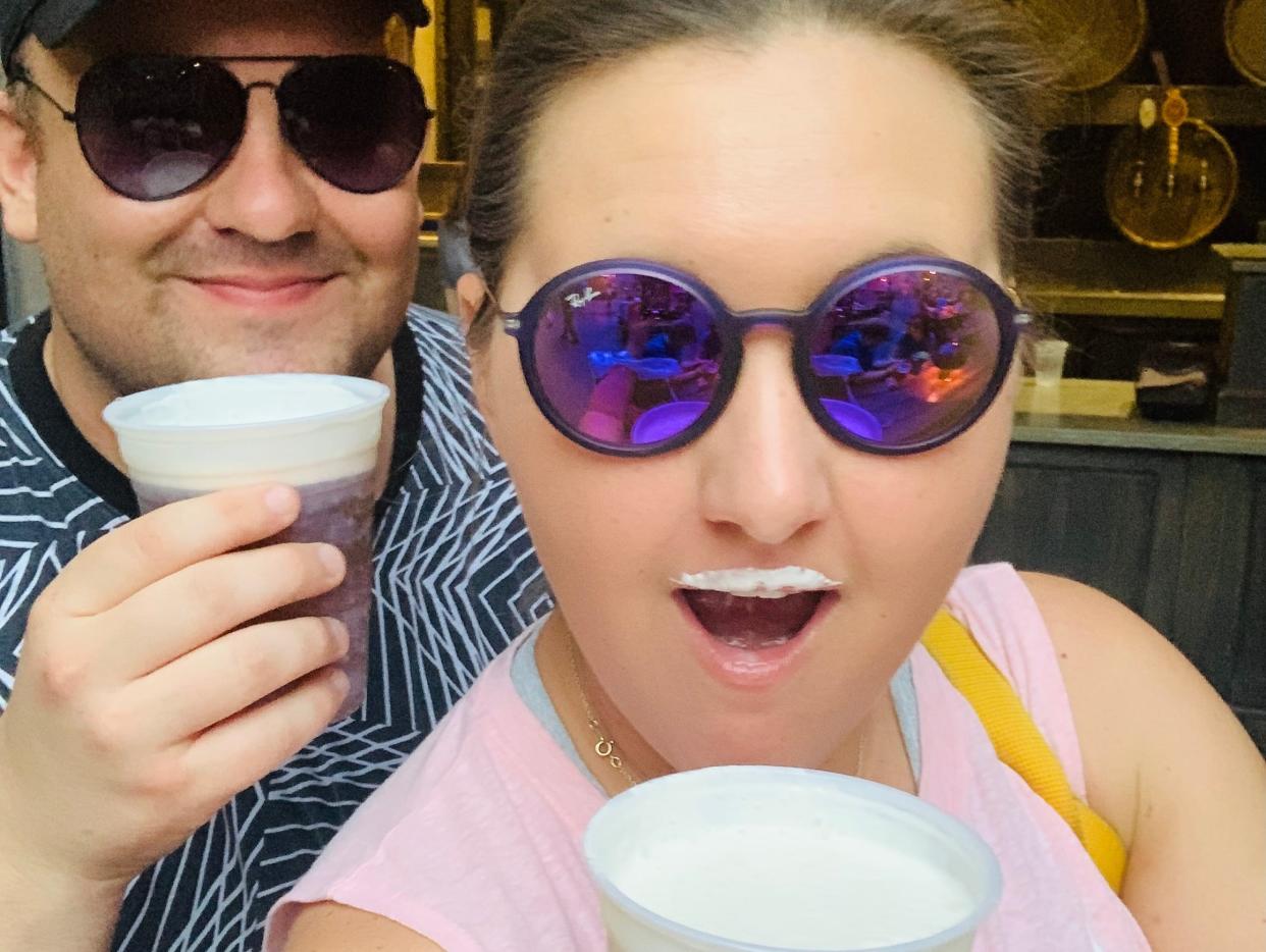 Carly Caramanna and her husband drinking butterbeer at universal studios orlando