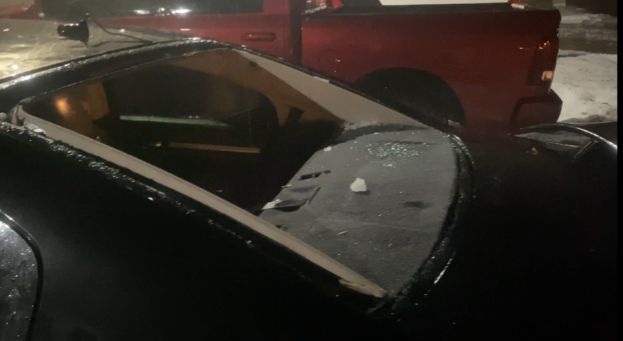A back windshield is missing glass with shards visible