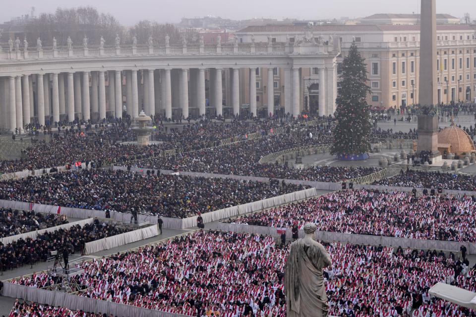 Faithful attend the funeral mass for late Pope Emeritus Benedict XVI in St. Peter's Square at the Vatican, Thursday, Jan. 5, 2023. Benedict died at 95 on Dec. 31 in the monastery on the Vatican grounds where he had spent nearly all of his decade in retirement.