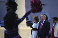 President Donald Trump and first lady Melania Trump watch as the Florida Atlantic University Marching Band performs during a Super Bowl party at the Trump International Golf Club in West Palm Beach, Fla., Sunday, Feb. 2, 2020. (AP Photo/Susan Walsh)