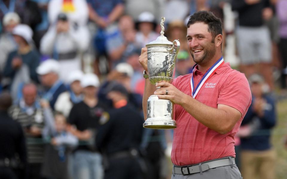 Jon Rahm celebrates with the trophy after winning he U.S. Open golf tournament at Torrey Pines Golf Course. - ORLANDO RAMIREZ 