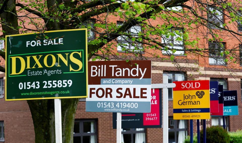 Property estate agent sales and letting signs are seen outside an apartment building in Lichfield, Britain, May 3, 2022. REUTERS/Andrew Boyers