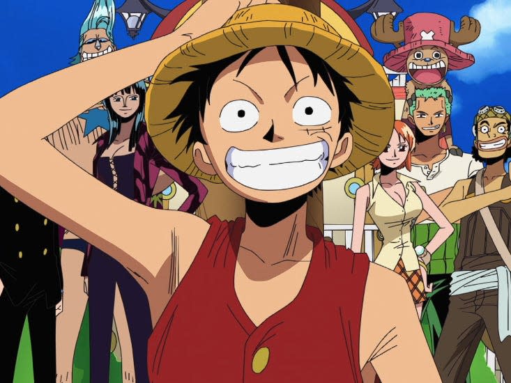 the straw hat pirates in the one piece anime, a crowd of people in brightly colored clothing. monkey d. luffy is in the foreground, a young man with a red vest, straw hat, and wide smile