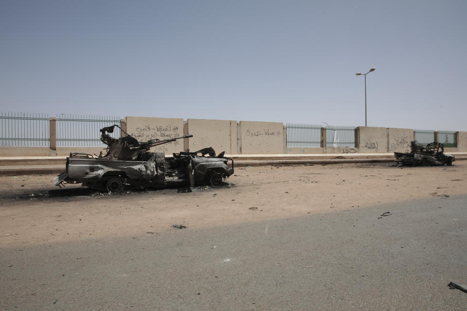 Destroyed military vehicles are seen in southern in Khartoum, Sudan, Thursday, April 20, 2023. The latest attempt at a cease-fire between the rival Sudanese forces faltered as gunfire rattled the capital of Khartoum. Through the night and into Thursday morning, gunfire could be heard almost constantly across Khartoum. (AP Photo/Marwan Ali)