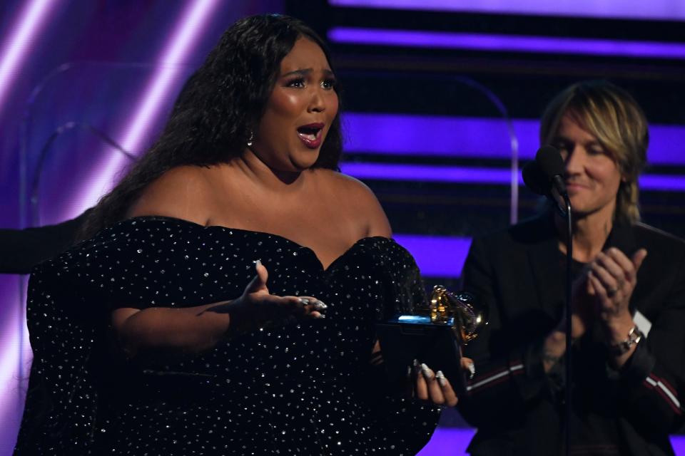 An emotional Lizzo accepts the award for best pop solo performance during the 62nd annual Grammy Awards.