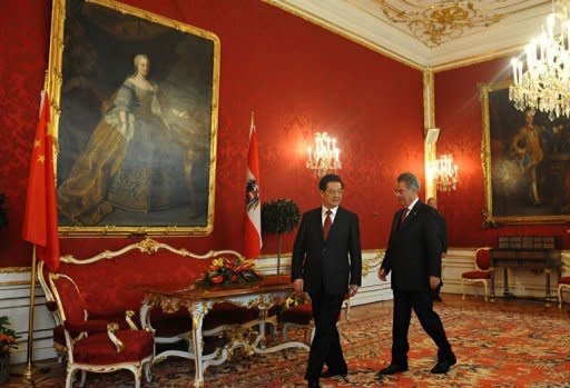 Austrian President Heinz Fischer (R) walks with his Chinese counterpart Hu Jintao during a welcoming ceremony in Vienna. China pledged "active support" to debt-stricken Europe and said it was "convinced" the EU could work through its current debt crisis, as Hu visited Vienna on Monday ahead of a G20 meeting