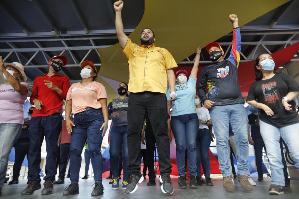 Nicolas Maduro Guerra, son of Venezuela's President Nicolas Maduro, campaigns for a spot in the National Assembly for the upcoming Dec. 6 midterm elections, in Maiquetía, Venezuela, Sunday, Nov. 29, 2020. (AP Photo/Ariana Cubillos)