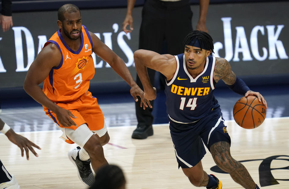 Denver Nuggets guard Gary Harris, right, drives past Phoenix Suns guard Chris Paul during the second half of an NBA basketball game Friday, Jan. 1, 2021, in Denver. The Suns won 106-103. (AP Photo/David Zalubowski)