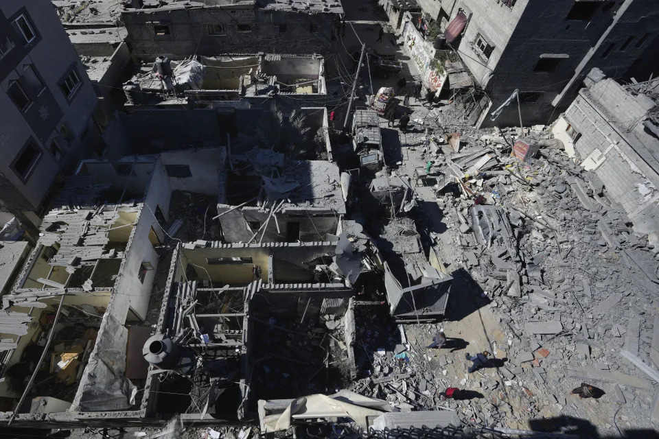 Palestinians inspect the rubble of destroyed buildings after an Israeli airstrike in Nusseirat refugee camp, central Gaza Strip, on Thursday, Feb. 29, 2024. (AP Photo/Adel Hana)