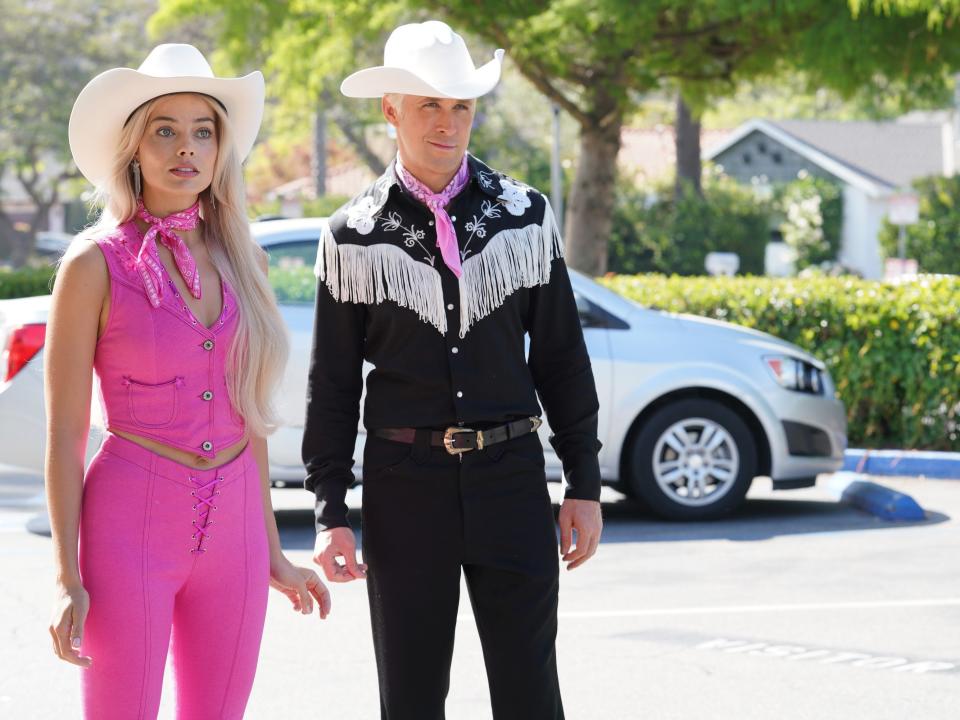Margot Robbie and Ryan Gosling dressed in western outfits as Barbie and Ken in "Barbie."