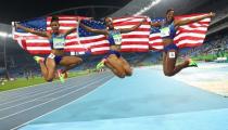 Brianna Rollins celebrates winning the gold medal with silver medallist Nia Ali and bronze medallist Kristi Castlin, all of USA in the women's 100m hurdles. REUTERS/Kai Pfaffenbach