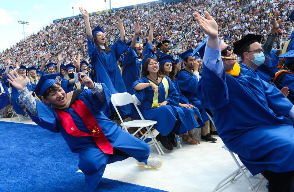 Graduates lean into the selfie being taken from the platform by University President Dennis Assanis with President Joe Biden during the University of Delaware's 2022 Commencement at Delaware Stadium, Saturday, May 28, 2022.