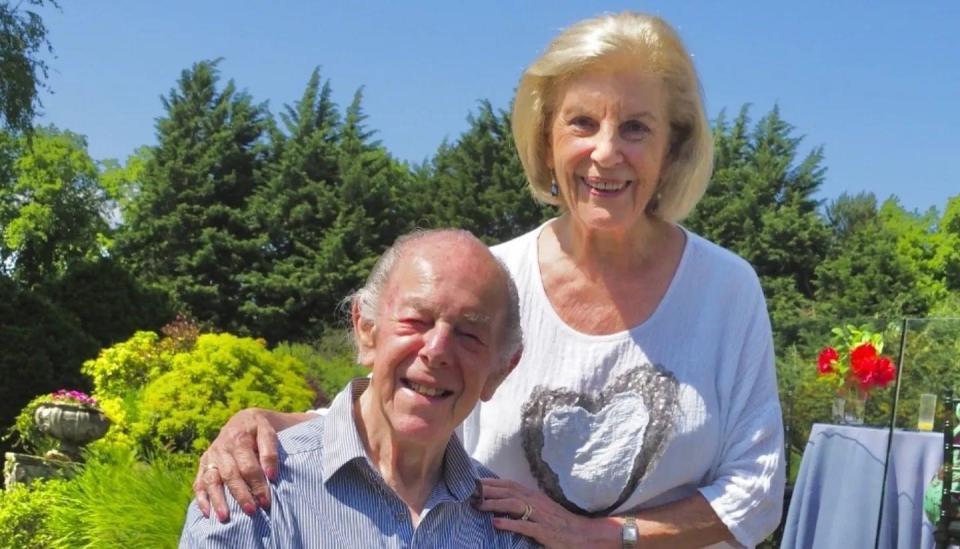 Myrna and Harvey Bernard pictured outdoors, with blue skies behind them