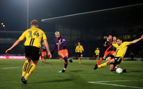 Sergio Aguero of Man City scores their 1st goal during the Carabao Cup Semi Final Second Leg match between Burton Albion and Manchester City at the Pirelli Stadium - Credit: Simon Stacpoole/Offside/Getty Images